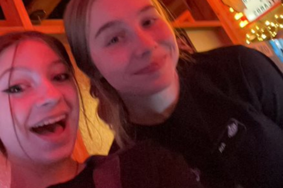 Hostesses Annie LeGrand and Ava Miller find time for a picture during a shift at their job at Texas Roadhouse.