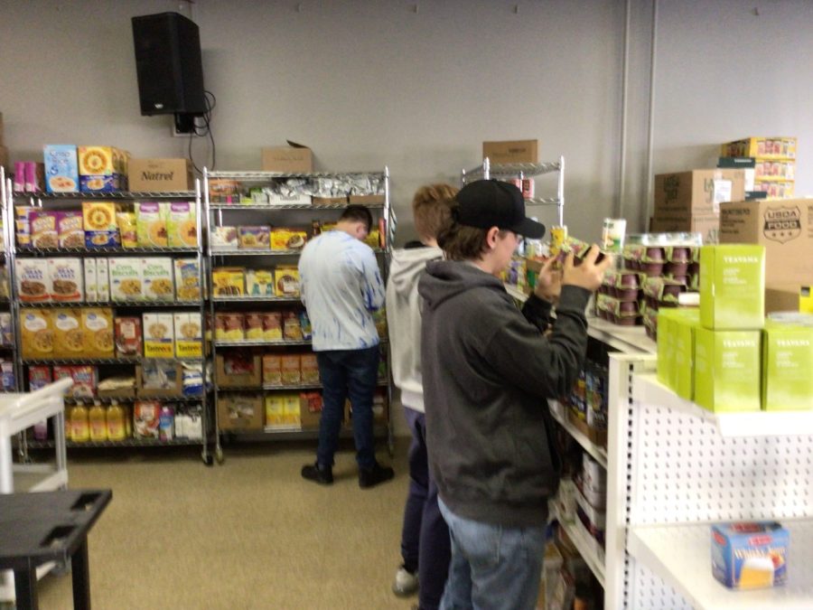 Students stock the shelves at the Hope Center on B-As Day of Giving.