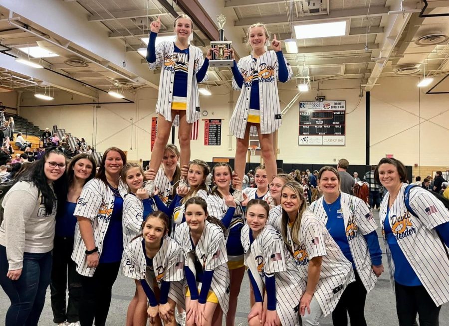 The junior high cheerleading team with its first place trophy.