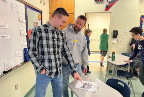 Kevin Stiver talks about the draft of his upcoming book on the history of Glen White with civics teacher Mr. Matthew McNaul.