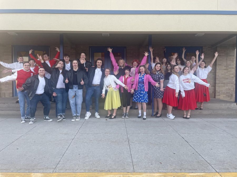 The whole Grease cast welcomes you to join them in their 50s fun.