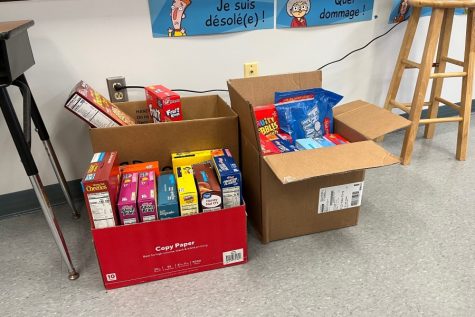 Mr. Van Scoyocs boxes are piled high with cereal donations. His homeroom leads the high school with a little more than a week left in the annual cereal drive.