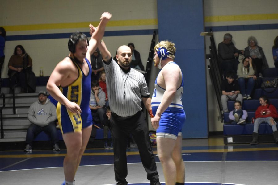 Ethan Norris gets his hand raised after a pin fall win against United.