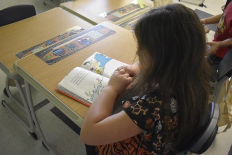 Myers students reading Dr. Seuss Books. Fewer young people are reading for pleasure. 