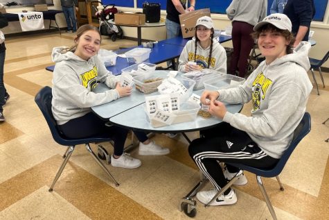 Ava Miller, Maliah Hassler, and Corry Shanafelt pack seeds to Unto.