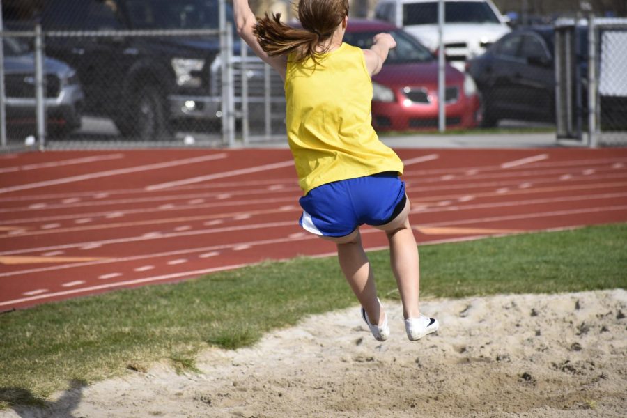 Briley Campbell mid air in the long jump (Bailee Conway)