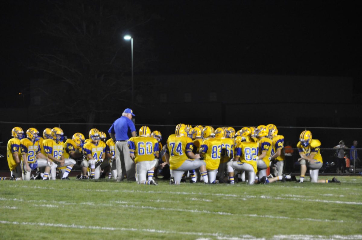 Coach Hayes gathers his team for a talk in 2015.