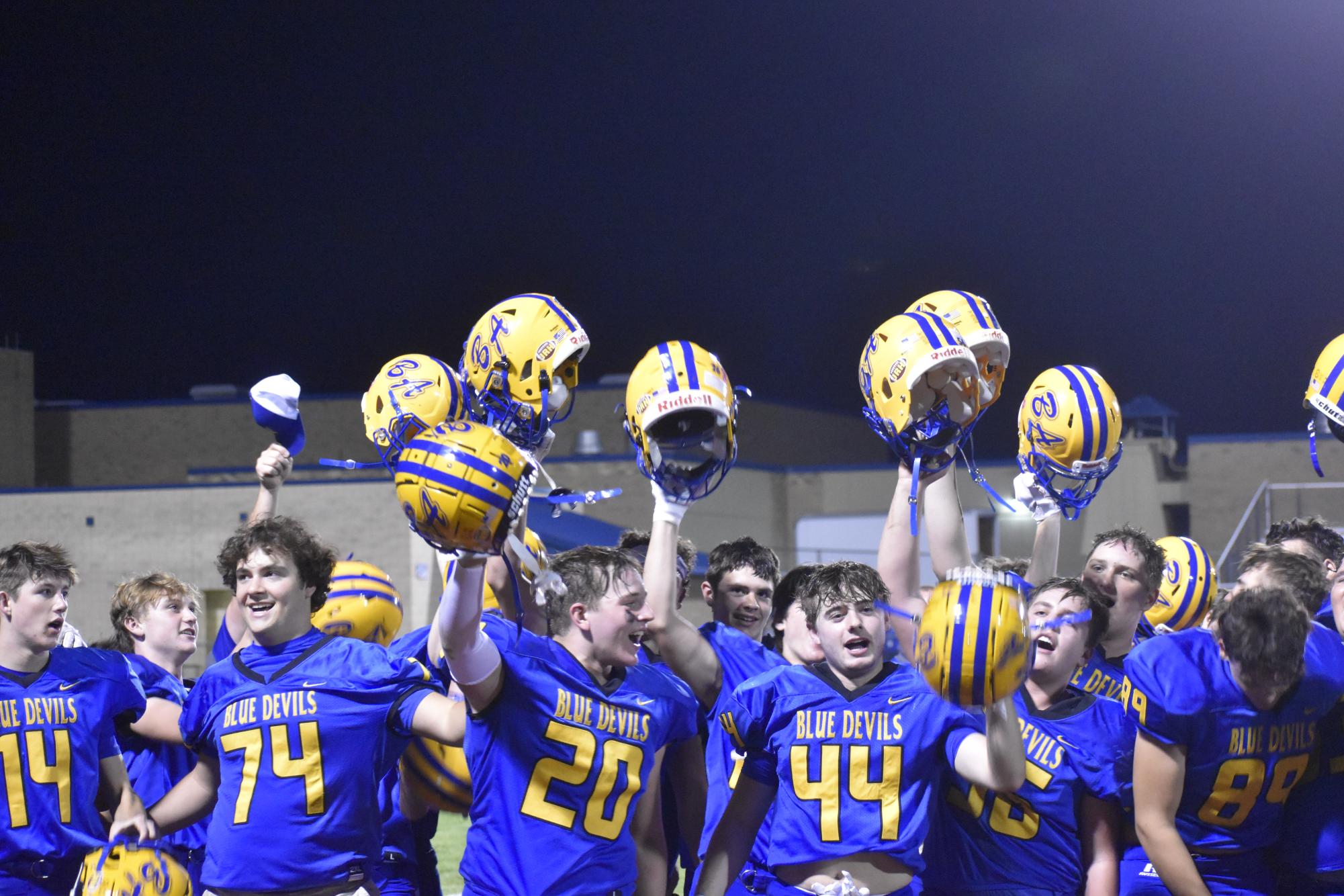 Bellwood football players celebrate after their win by singing the alma mater. 