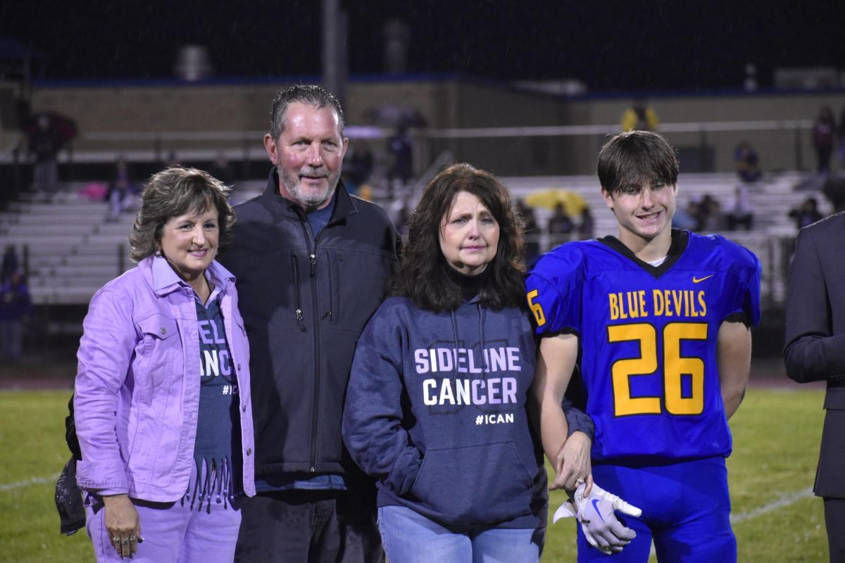 Sideline+Cancers+Cathy+Griffith+was+on+hand+at+Homecoming+to+show+support+for+Bellwood+resident+Melody+Plummer.+Both+Melodys+husband+Jeff+and+grandson+Chase+were+also+there+at+halftime+when+Sideline+Cancer+presented+her+with+a+check+for+more+than+%245%2C000.+