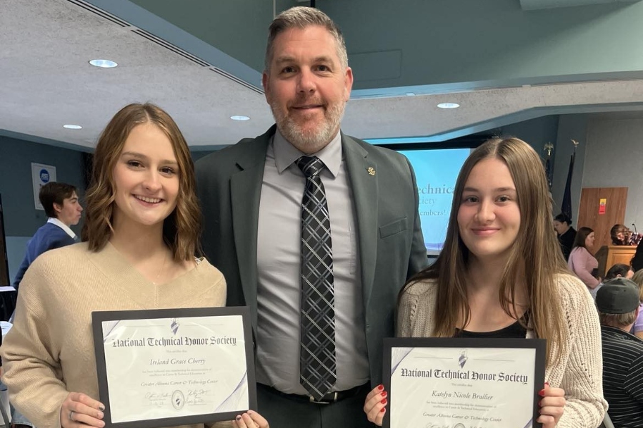 Ireland Cherry, left, and Katelyn Brallier, right, pose with high school principal Mr. Richard Schreier after being inducted into the National Technical Honor Society.