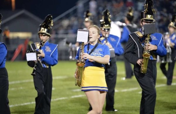 Lindsey Brinkman (Sophomore) took a huge leap by participating in both marching band and cheerleading last season.