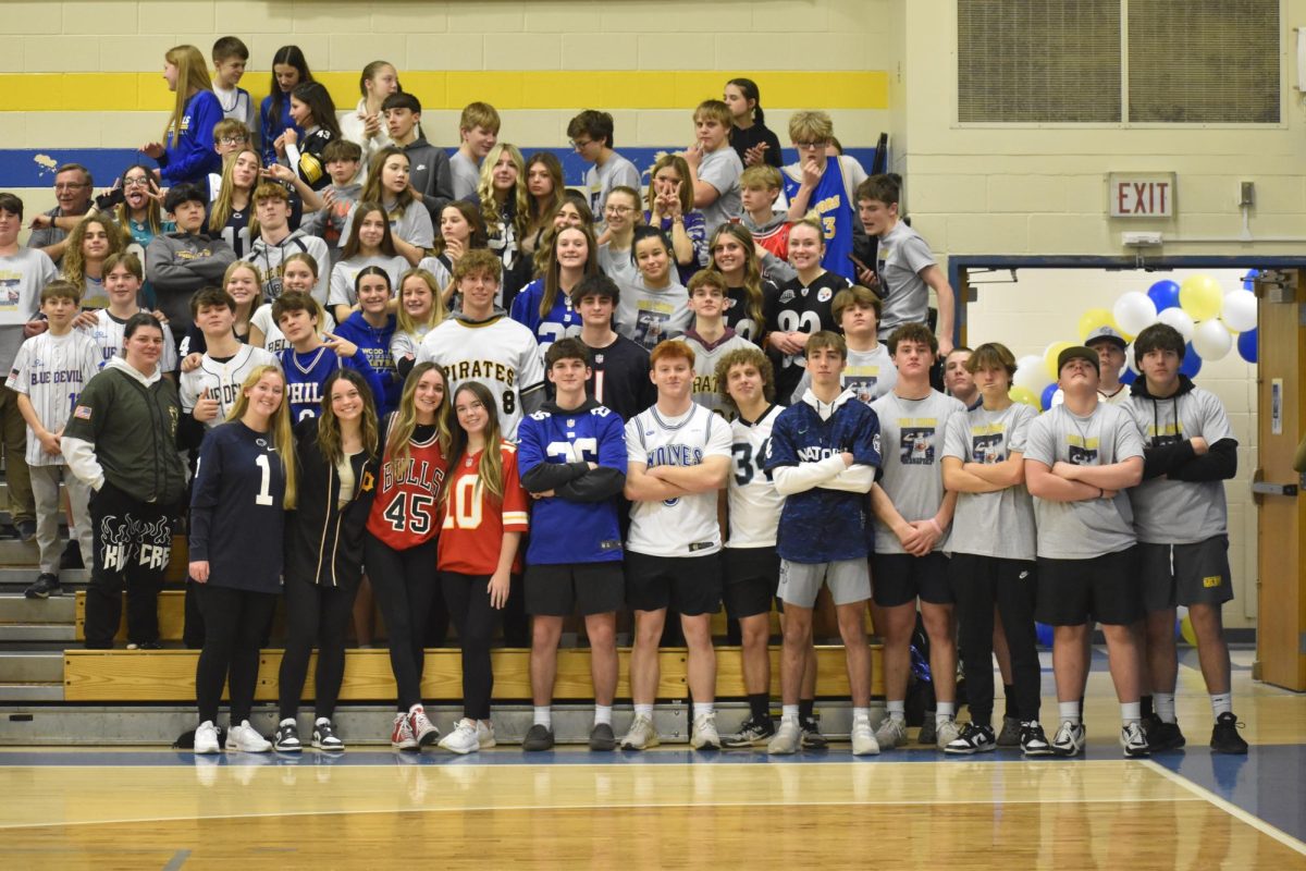 The student section shows support for their seniors by wearing jerseys.