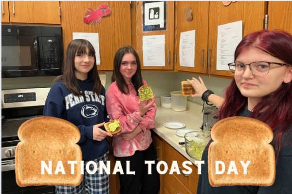 Anna Wilt, Maddie Larson, and Ava Cooley display their toasted creations from Ms. Harriss class.