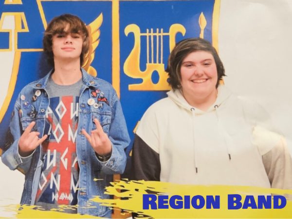 A poster hangs beside the band room with Anthony Berardi (Left) and Abi Eckenrod (Right) who both attended region band late February.