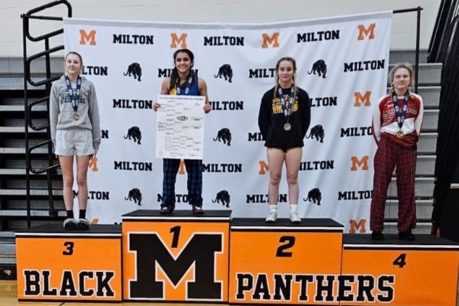 Juliette+Cuevas+displays+her+winning+bracket+on+the+podium+at+Milton+Area+High+School+on+Saturday.+Cuevas+won+the+regional+tournament+at+100+pounds+and+advanced+to+the+PIAA+championships.