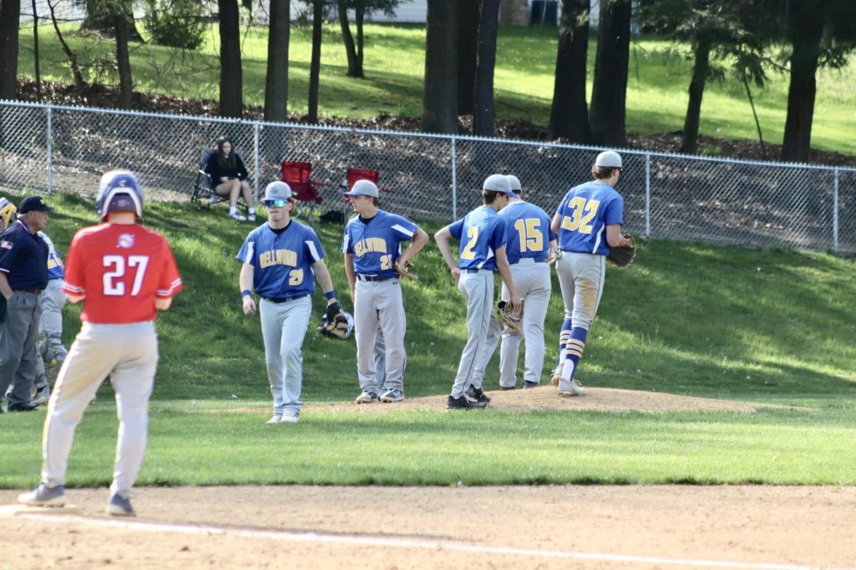Baseball team meets at the mound