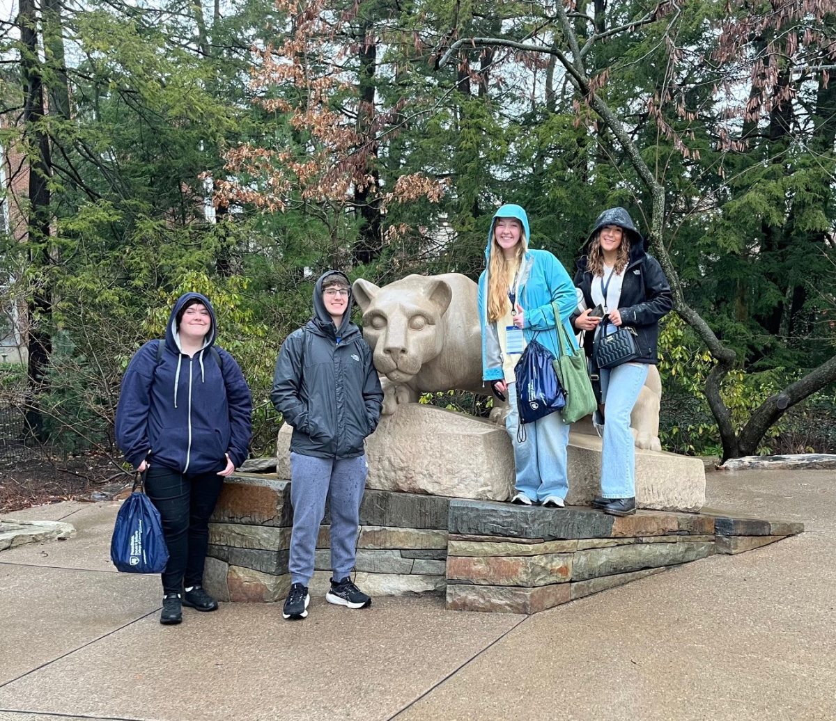 Abi Eckenrod, Jordan Hescox, Olivia Hess, and Chloe Brown pose at the Nittany Lion shrine at Penn State University. The students were on campus last week for the PSPA state journalism contest.