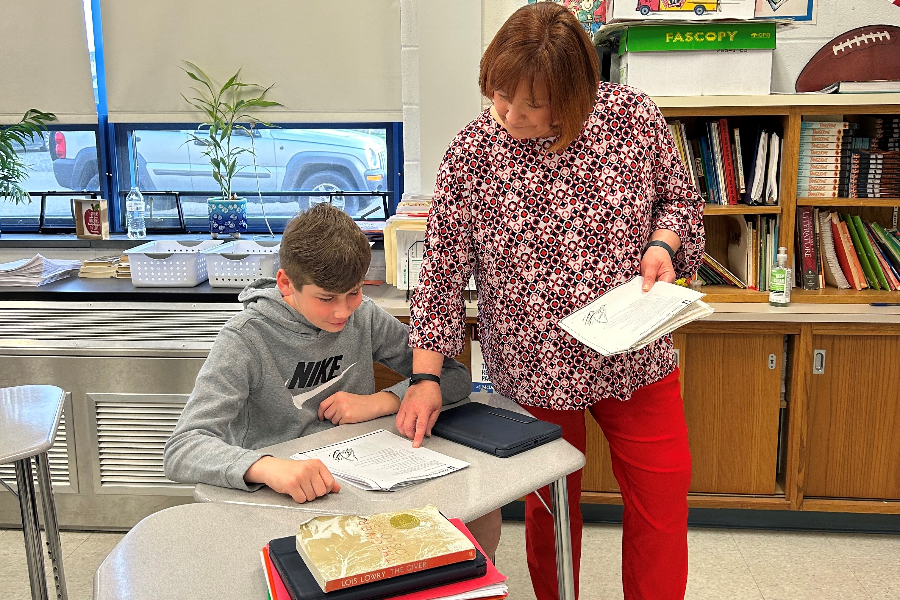 Mrs. Nycum assists a student in her seventh grade reading class. She plans on retiring in May after 33 years at Bellwood-Antis.