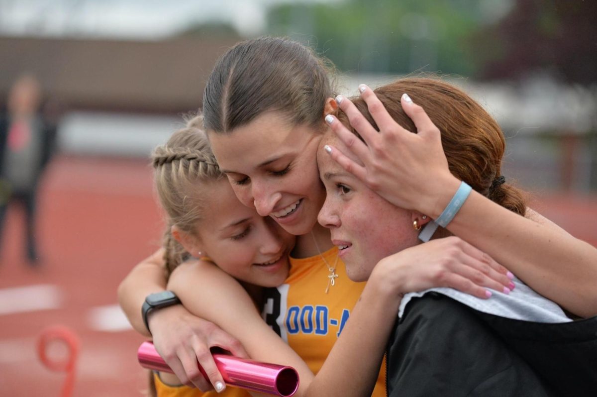 Avah Hassler celebrates with Julie Kraft and Marissa Cacciotti after running the anchor leg of the 4x400 relay at the District 6 2A championships yesterday at Mansion Park. The team qualified for finals on Wednesday.
