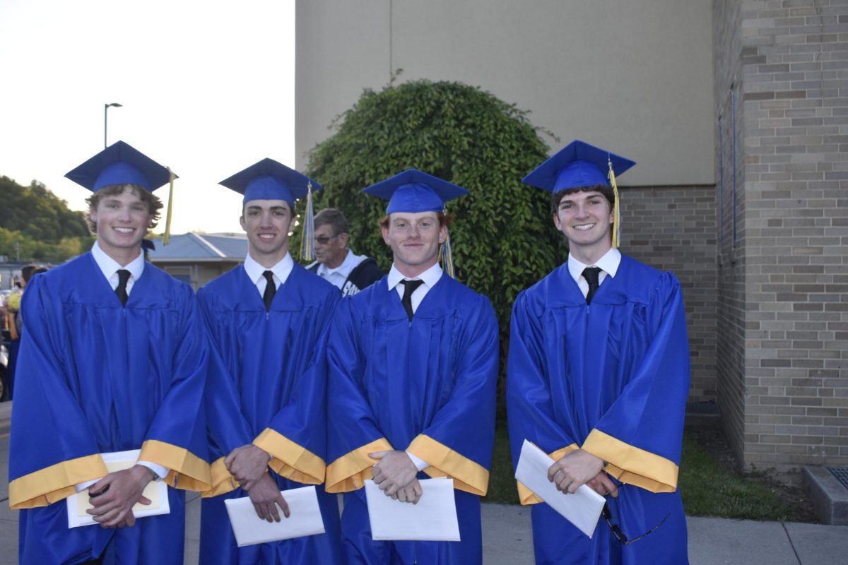 Connor Cobaugh, Chris Walls, Zach Pier, and Ethan Johnston smile with their diplomas at 2024 commencement.