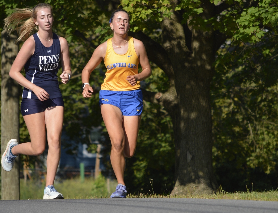 Blake Pennington battles to maintain a first-place lead over Penns Valley's Lillyana Smith Wednesday in Bellwood. Pennington finished second, but the Lady Devils won the cross country meet after placing 7 runners in the top 10.