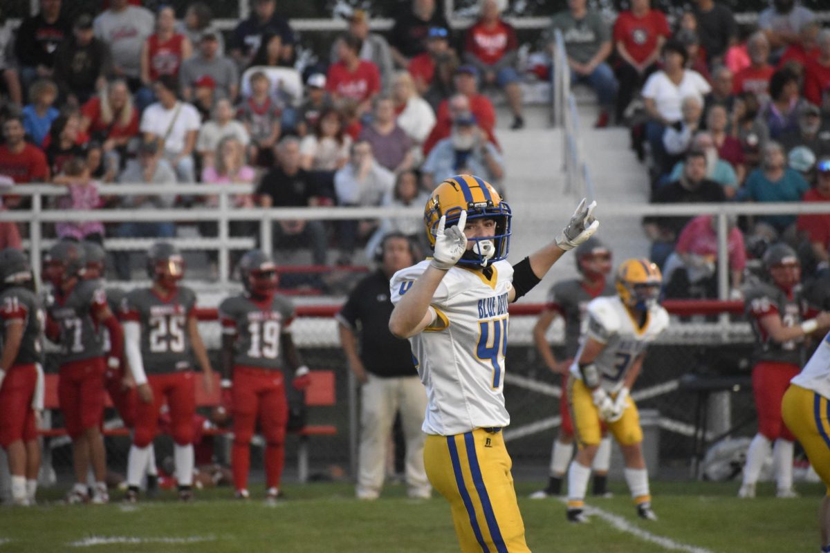 Griffin Kyle puts up "Devils Horns" at the game versus Central Dragons