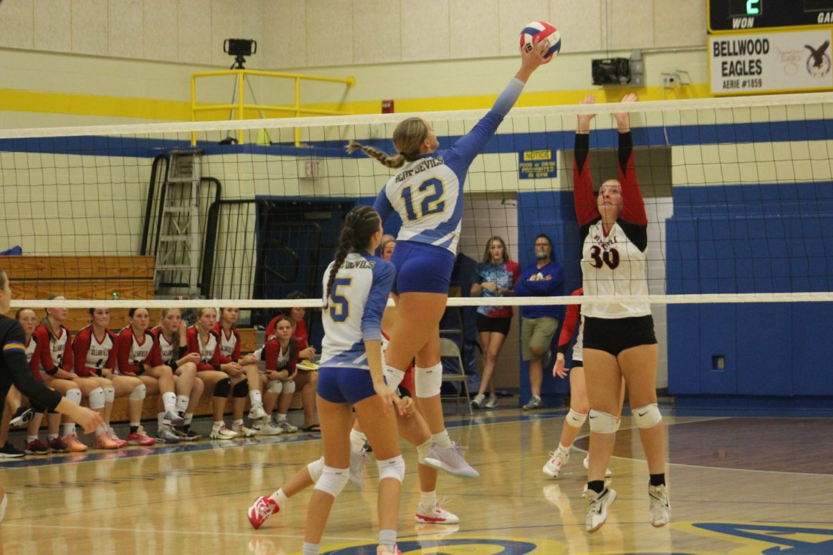 Addy Turek spikes the ball over the net. 