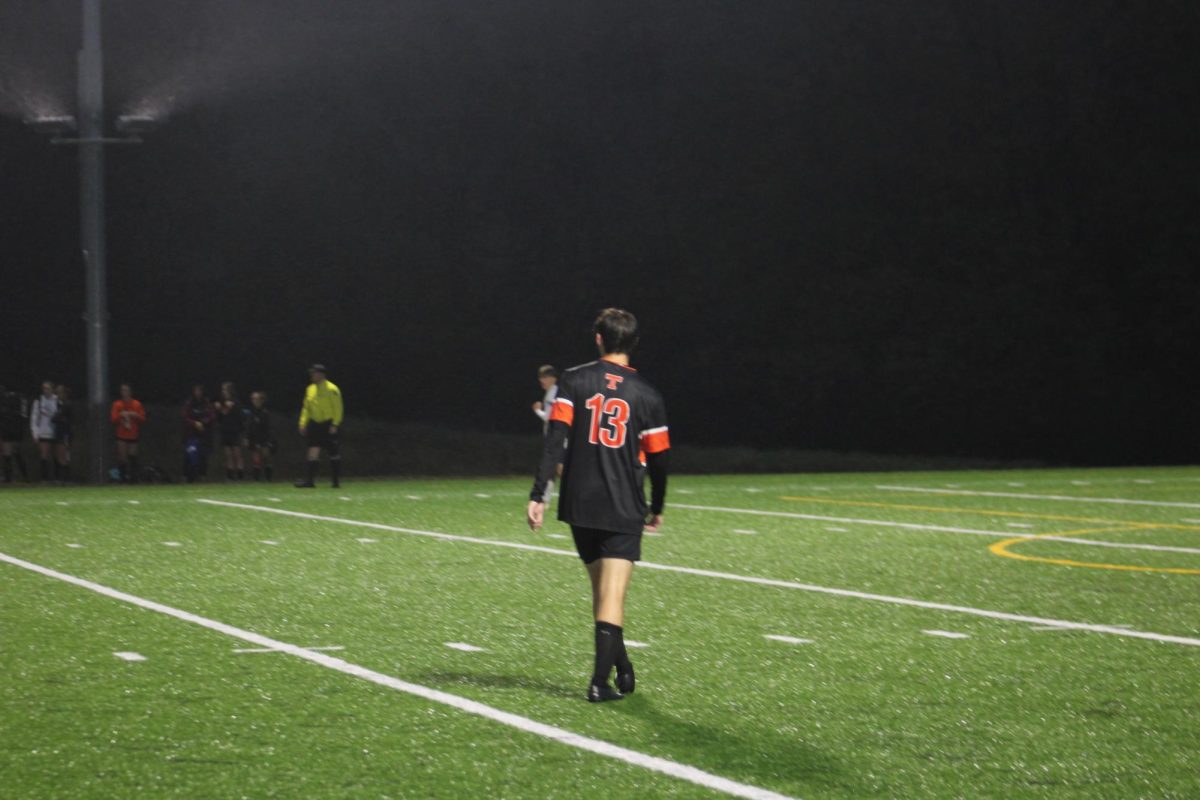 Jake Baker walks across a chilly and windy field in Tyrone during the soccer team's 2-1 victory over Bishop McCort last night.