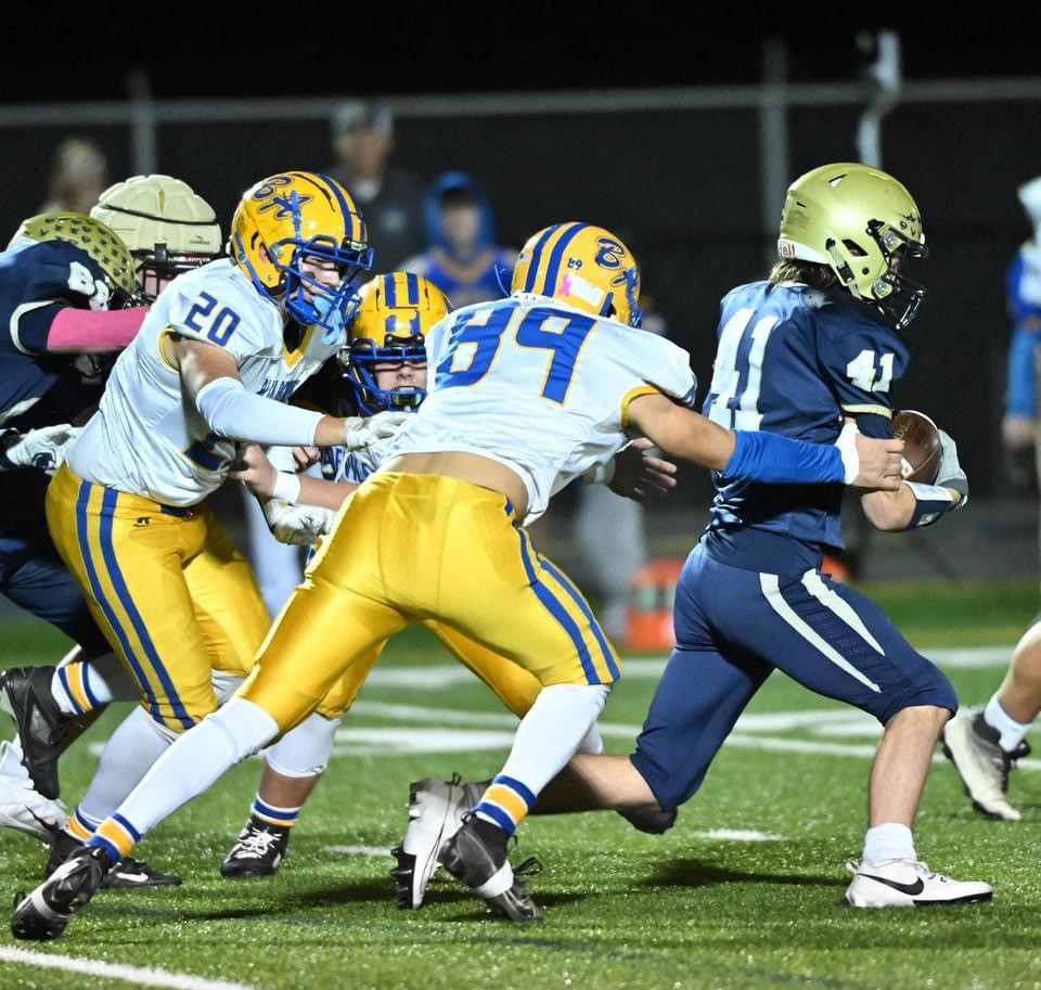 Blue Devil defenders Cayden Pellegrine and Jordan Hance chase down BEA's Nick McCully Friday. The Blue Devils won the game 32-18.