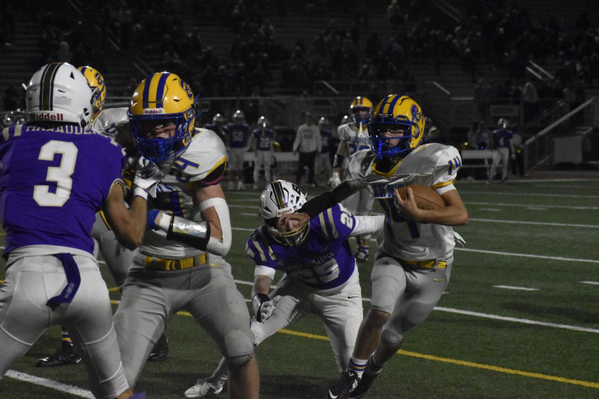 Holden Schreier runs the football with Ethan Shawley blocking for him.