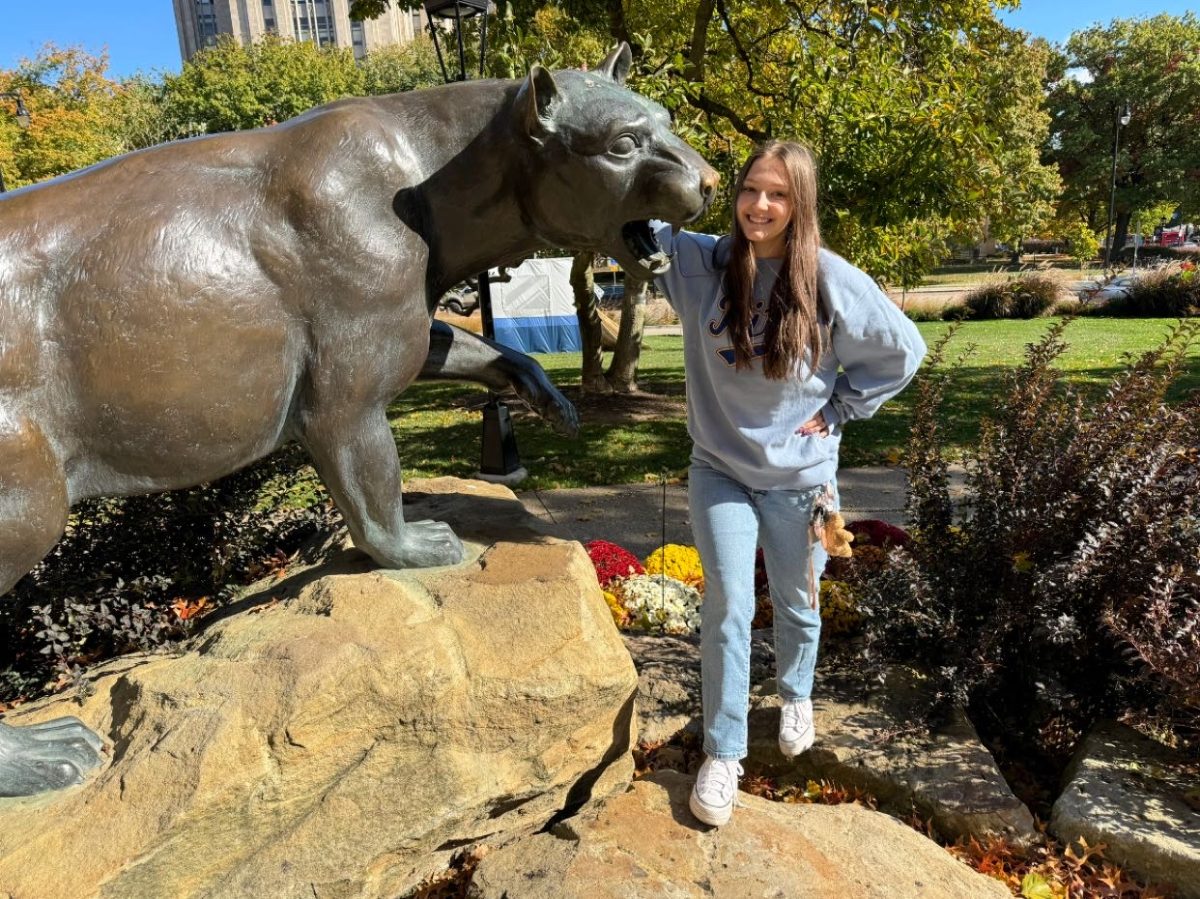 Halee Young pictured with Pittsburgh’s mascot (Roc the Panther) 