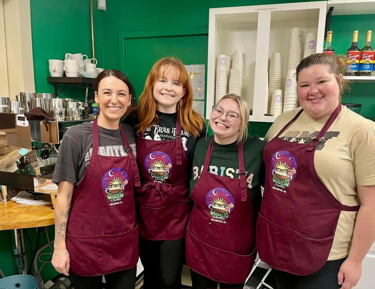 Senior Morgan Kienzle keeps a full schedule, not only serving as the BluePrint's sports photographer but working two job s and keeping up her grades. Here, Morgan, second from left, poses with friends from her job at Cosmic Charlie's Coffee House.