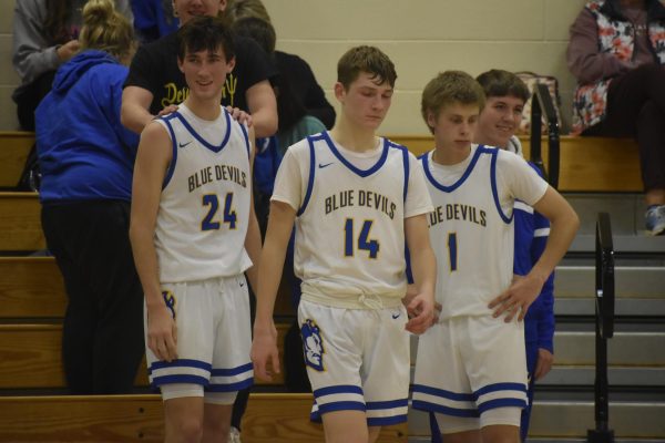 Starting boys basketball players getting ready for the second half.