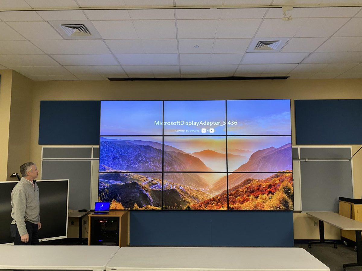 Mr. Stinson shows off the massive TV in the Myers LGI room that's actually built of 9 separate flat screens.