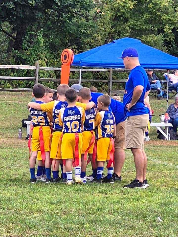 Zach McCaulley stands with his team at a BAYFL flag game earlier this year.