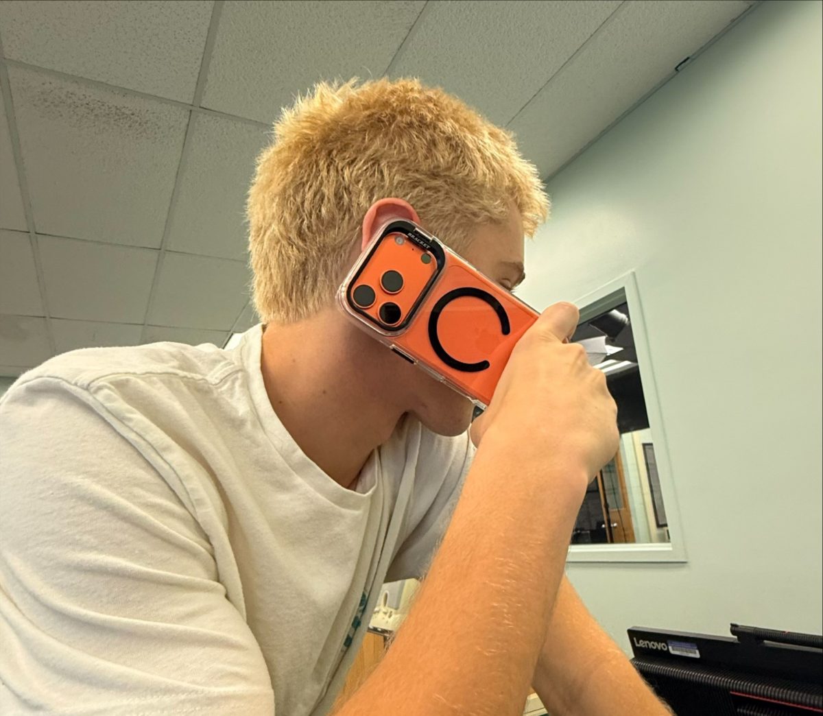 Jackson Dorminy tries out the iPhone 17 in the new cosmic orange color.