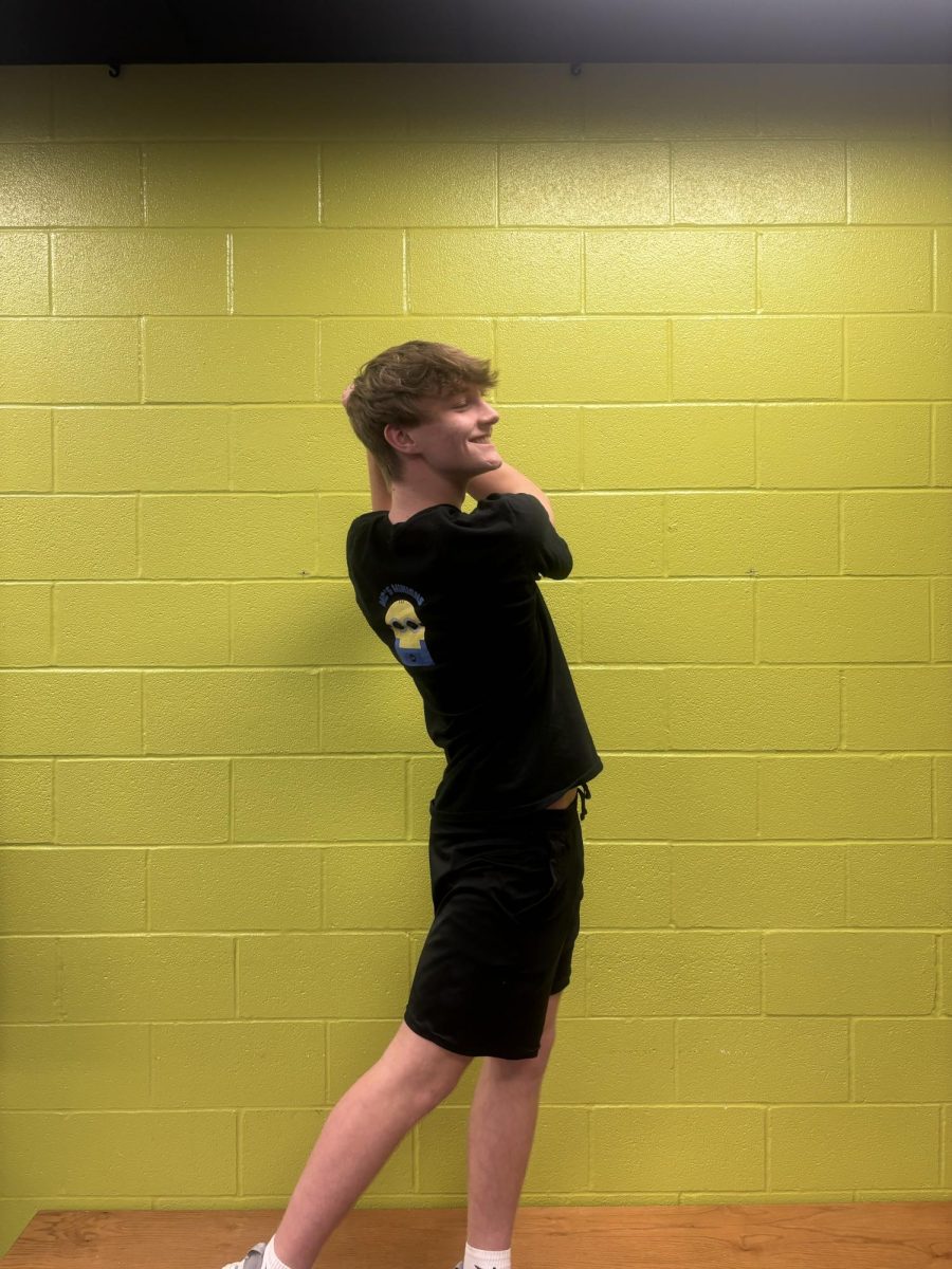 Maddox McCall replicating his golf swing, which he perfects daily on Tate Baughman's golf simulator.