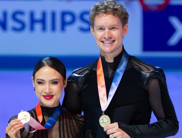 Madison Chock and Evan Bates receive their medals for mixed teams.