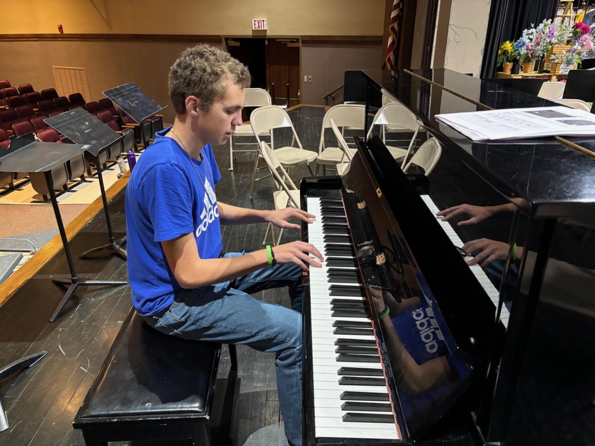 Jace Rimmey practices the piano in the auditorium. Jace has been tinkering with the piano for several years, while also  building his skills as a drummer and a singer.