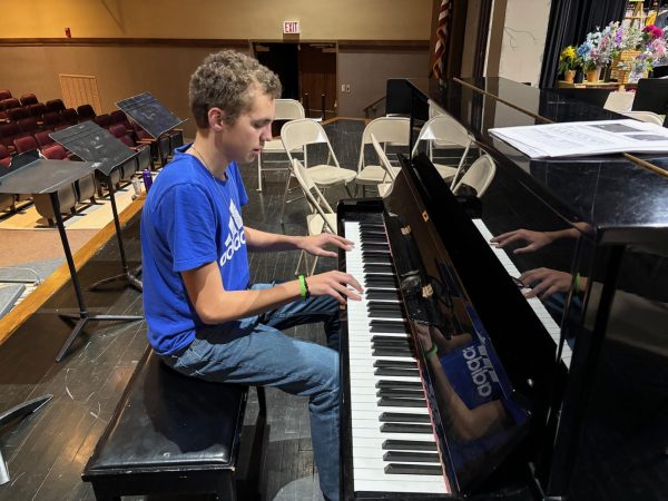 Jace Rimmey practices the piano in the auditorium. Jace has been tinkering with the piano for several years, while also  building his skills as a drummer and a singer.