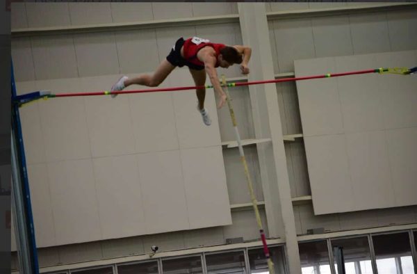 Dylan Andrews pole vaulting in a meet for Saint Francis University.
