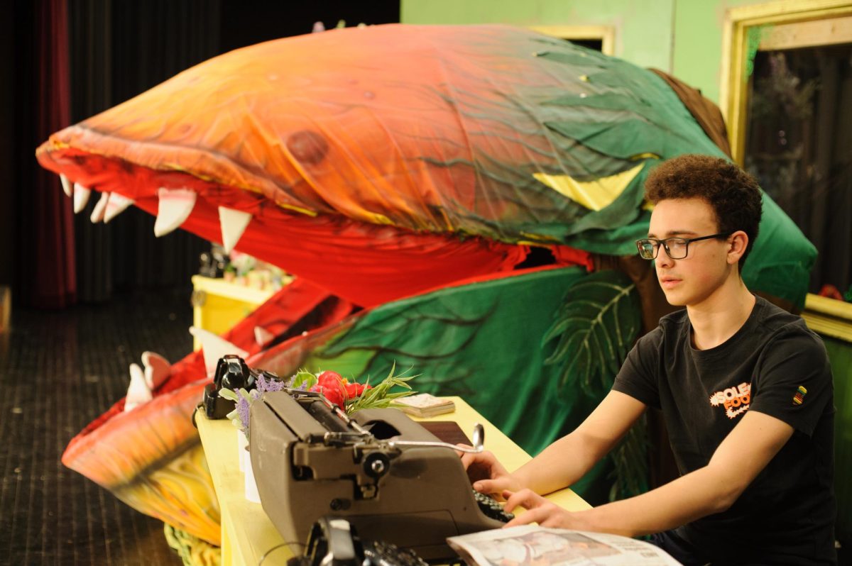 Collin Matthews and the Little Shop of Horrors cast practice before opening night. The play premiers March 26.
