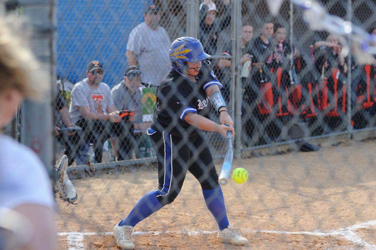 London McKee hits a line drive down the center