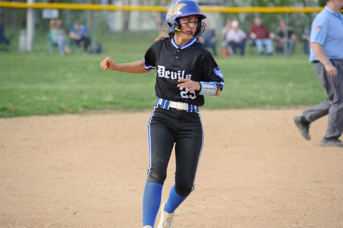 Parker Martin pulls into third after advancing from first on a hit to the outfield.