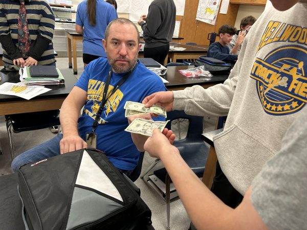 Students showing appreciation to Dr. Martin by giving him money.