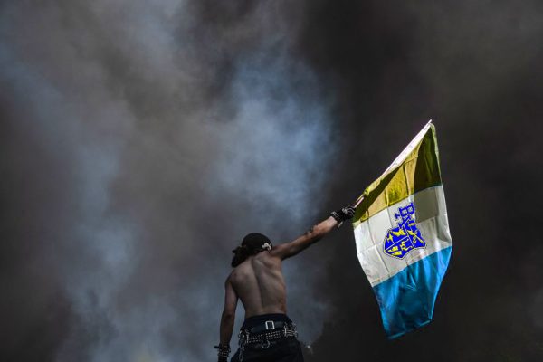 A middle school student holds the flag of New Bellwood after detonation a fart bomb.